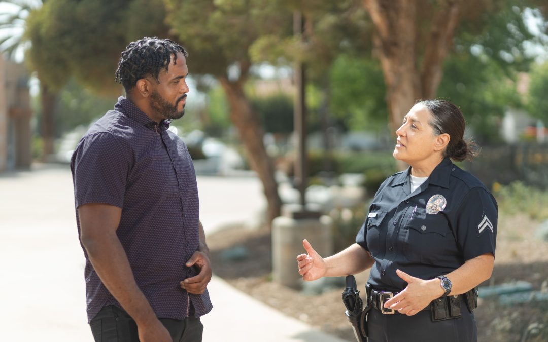 police officer speaking with a pedestrian